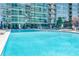 Relaxing outdoor pool area with lounge chairs in front of a high-rise condo building at 923 Peachtree Ne St # 1628, Atlanta, GA 30309