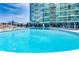 Outdoor pool with lounge chairs and umbrellas set in front of high rise building at 923 Peachtree Ne St # 1628, Atlanta, GA 30309
