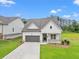 An aerial shot of a charming one-story home with a well-manicured lawn, two car garage, and green space at 1101 Cooks Farm Way, Woodstock, GA 30189