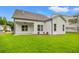 Backyard featuring a covered patio and a spacious lawn, ideal for outdoor activities and relaxation at 1101 Cooks Farm Way, Woodstock, GA 30189