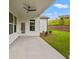 Covered patio with a ceiling fan and a view of the well maintained backyard and landscaped green space at 1101 Cooks Farm Way, Woodstock, GA 30189