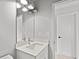 Modern bathroom with a stylish vanity, a sleek mirror, and contemporary lighting at 1101 Cooks Farm Way, Woodstock, GA 30189