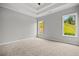 Spacious bedroom featuring neutral walls, carpeted floors, and natural light from two windows at 1101 Cooks Farm Way, Woodstock, GA 30189