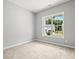 Neutral bedroom featuring carpeted floors, a window with natural light, and modern ceiling features at 1101 Cooks Farm Way, Woodstock, GA 30189
