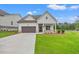 Charming one-story home with white siding, a covered porch, a well-manicured lawn and a two car garage at 1101 Cooks Farm Way, Woodstock, GA 30189