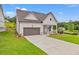 Charming single-story home featuring a two-car garage, manicured lawn, and welcoming front porch at 1101 Cooks Farm Way, Woodstock, GA 30189