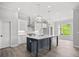 Modern kitchen with a large island, stainless steel appliances, and pendant lighting at 1101 Cooks Farm Way, Woodstock, GA 30189
