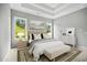 Serene bedroom offers natural light, tray ceilings, and neutral decor that create a peaceful retreat at 1101 Cooks Farm Way, Woodstock, GA 30189