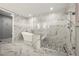 A modern bathroom with marble tile, a freestanding tub, and a glass shower with a bench and showerhead at 270 17Th Nw St # 2804, Atlanta, GA 30363
