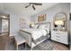 Bright primary bedroom with hardwood floors, a ceiling fan, and a king bed with white linens and a padded headboard at 270 17Th Nw St # 2804, Atlanta, GA 30363