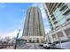 Modern high-rise condominium exterior showcasing its impressive height against a clear, blue sky at 270 17Th Nw St # 2804, Atlanta, GA 30363