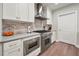 Bright kitchen with marble backsplash, stainless steel appliances and wood flooring at 270 17Th Nw St # 2804, Atlanta, GA 30363