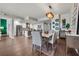 Open-concept kitchen and dining area with stainless steel appliances, hardwood floors, and a modern light fixture at 270 17Th Nw St # 2804, Atlanta, GA 30363