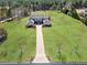 Aerial view of a grand home on a large, well-manicured lot, complete with an extra-long driveway at 525 Waters Way, Fayetteville, GA 30215
