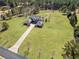 Aerial view of the stunning home on expansive property with a pond and tree lined perimeter offering both space and privacy at 525 Waters Way, Fayetteville, GA 30215