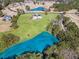 A breathtaking aerial view reveals a home with spacious green grounds, and an adjacent serene pond at 525 Waters Way, Fayetteville, GA 30215