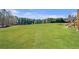 Expansive backyard with lush green lawn and wooden stairs provides a beautiful outdoor space for recreation and relaxation at 525 Waters Way, Fayetteville, GA 30215