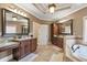 Spacious bathroom featuring double vanities, a soaking tub, and tiled floors at 525 Waters Way, Fayetteville, GA 30215
