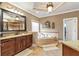Elegant bathroom featuring a soaking tub, granite countertops, and custom cabinetry at 525 Waters Way, Fayetteville, GA 30215