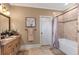 Well-lit bathroom boasts a soaking tub, a granite-topped vanity, and neutral colors at 525 Waters Way, Fayetteville, GA 30215