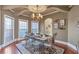 Beautiful dining room with a coffered ceiling, hardwood floors, and large windows offering abundant natural light at 525 Waters Way, Fayetteville, GA 30215