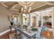 Bright dining room featuring hardwood floors, a decorative chandelier, and an open layout ideal for entertaining at 525 Waters Way, Fayetteville, GA 30215
