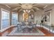 Elegant dining room boasts wood floors, large windows, and an ornate chandelier adding a touch of sophistication at 525 Waters Way, Fayetteville, GA 30215