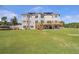 Back exterior view with large deck and lots of windows for natural light showing an expansive backyard at 525 Waters Way, Fayetteville, GA 30215