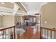 Open hallway with hardwood floors, decorative ceilings, and views of the home office at 525 Waters Way, Fayetteville, GA 30215