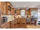Well-appointed kitchen featuring custom cabinets, granite countertops, and stainless-steel appliances perfect for cooking enthusiasts at 525 Waters Way, Fayetteville, GA 30215