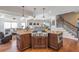 Open-concept kitchen with stainless steel appliances, a center island, and easy access to the staircase and living area at 525 Waters Way, Fayetteville, GA 30215