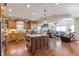 Open kitchen featuring custom cabinets, stainless steel appliances, a center island, and easy access to the living area at 525 Waters Way, Fayetteville, GA 30215