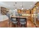 Bright kitchen featuring stainless steel appliances, an island with seating, and seamless access to the living and dining areas at 525 Waters Way, Fayetteville, GA 30215
