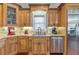Updated kitchen features custom cabinetry, granite countertops, and stainless-steel appliances providing great functionality at 525 Waters Way, Fayetteville, GA 30215