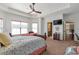 Comfortable main bedroom with backyard views, a ceiling fan, and access to an ensuite bathroom at 525 Waters Way, Fayetteville, GA 30215