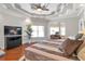 Bright main bedroom showcasing a decorative ceiling, hardwood floors, and lots of natural light at 525 Waters Way, Fayetteville, GA 30215