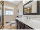 Well-lit bathroom featuring a modern vanity, stylish mirror, and a shower with glass door at 731 Fern Se St, Marietta, GA 30067