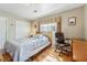 Cozy bedroom with hardwood floors, a comfortable bed, and a dedicated workspace at 731 Fern Se St, Marietta, GA 30067