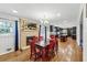 Open dining area with fireplace that flows into a kitchen with dark cabinets and island at 731 Fern Se St, Marietta, GA 30067