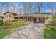 Traditional home showcasing a long driveway, neutral siding, and a welcoming covered front porch at 731 Fern Se St, Marietta, GA 30067