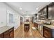 Spacious kitchen with stainless steel appliances and granite countertops, open to the living spaces at 731 Fern Se St, Marietta, GA 30067