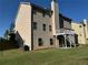 Back exterior featuring a manicured lawn, multi-story, and raised deck at 4038 Se Clay Court Se Se, Conyers, GA 30013