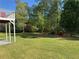 Spacious backyard with mature trees, adjacent to a raised deck and stairs at 4038 Se Clay Court Se Se, Conyers, GA 30013