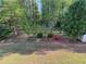 Expansive backyard with mature trees, sitting area, and storage shed at 4038 Se Clay Court Se Se, Conyers, GA 30013