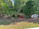 Large backyard featuring a storage shed, manicured lawn, and mature trees at 4038 Se Clay Court Se Se, Conyers, GA 30013