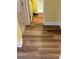 Bathroom doorway with orange rugs, yellow walls, and new wooden flooring at 4038 Se Clay Court Se Se, Conyers, GA 30013