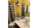 Bright bathroom with a neutral patterned shower curtain, vanity, and decorative towels and wall decor at 4038 Se Clay Court Se Se, Conyers, GA 30013