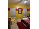 Bright bedroom with red and yellow color scheme, featuring a comfortable bed and large window with natural light at 4038 Se Clay Court Se Se, Conyers, GA 30013