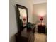 Bedroom dresser, mirror, and lamps in a neutral-toned space with a minimalist style at 4038 Se Clay Court Se Se, Conyers, GA 30013