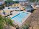 Aerial view of community pool, playground, and clubhouse showcasing the neighborhood's amenities at 5884 Grande River Rd, Atlanta, GA 30349